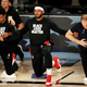 Carmelo Anthony of the Portland Trail Blazers kneels with teammates and coaches during the national anthem before the game against the Memphis Grizzlies at The Arena at ESPN Wide World Of Sports Complex on July 31, 2020 in Lake Buena Vista, Florida.